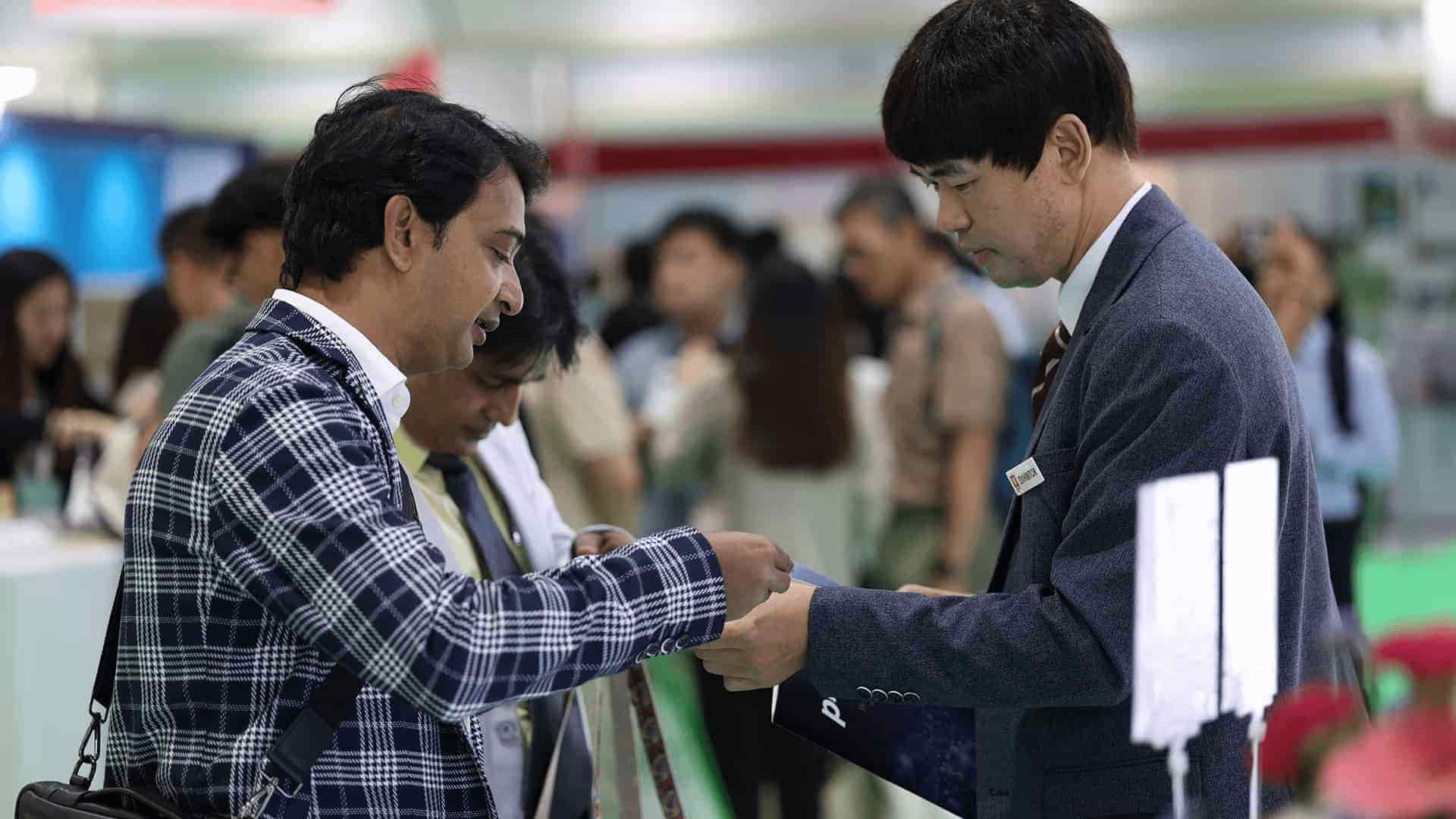 Visitor taking sample from exhibitor at Vitafoods Asia