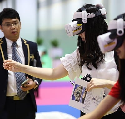 Two attendees at Vitafood Asia enjoying a VR demonstration.