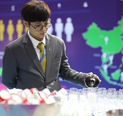 Vitafoods Asia exhibitor pouring out samples